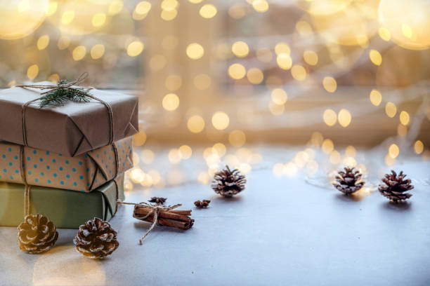 istock Christmas zero waste packaging gift boxes with pine cones, wooden eco decor and Christmas lights 1350387771