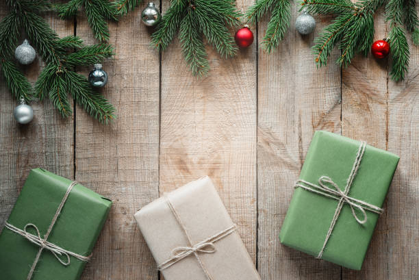 istock Gift boxes on Christmas background with pine tree branches and Christmas baubles 1350387835