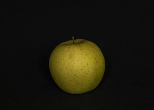 green apple on a black background, apple close-up