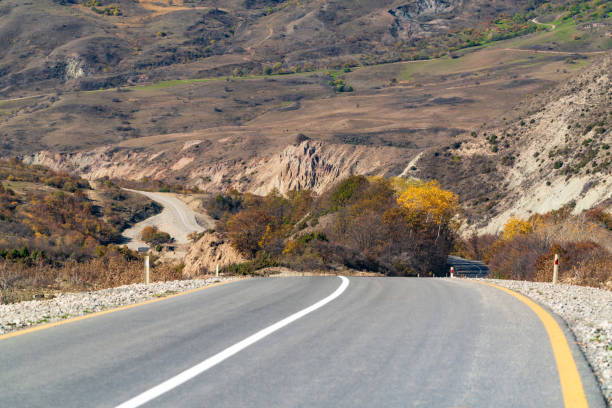 istock Turning on an asphalt mountain road 1350392102