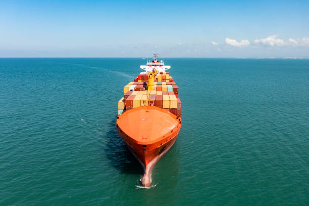 istock Aerial view of a container cargo ship traveling over open sea. 1350393263