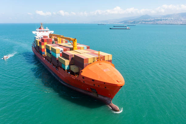 istock Aerial view of a container cargo ship traveling over open sea. 1350394475