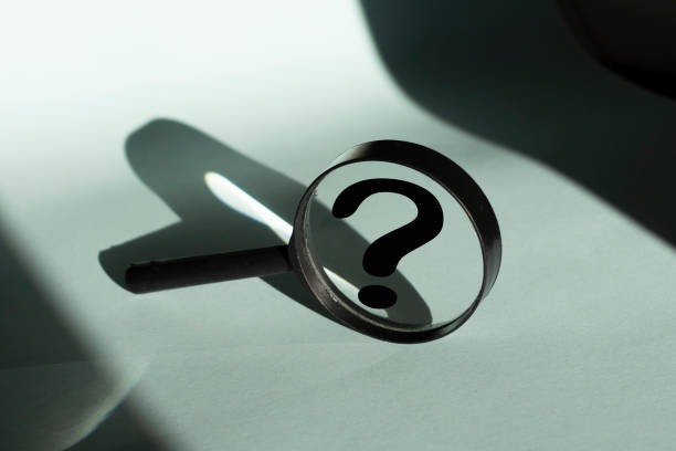 istock Black Magnifying glass and a question WHY . FAQ frequency asked questions, Answer and Brainstorming Concepts. Minimal creative concept. 1350395649