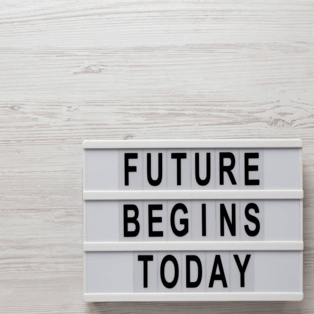 istock 'Future begins today' words on a lightbox on a white wooden background, top view. Overhead, from above, flat lay. Copy space. 1350396896