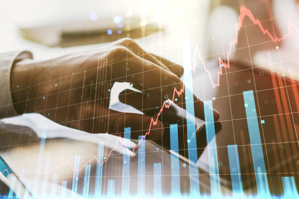 istock Abstract creative financial graph with finger clicks on a digital tablet on background, forex and investment concept. Multiexposure 1350397881