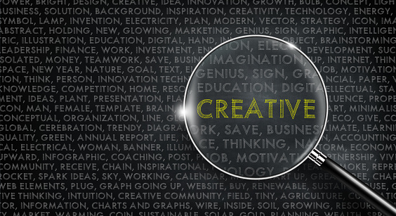 Magnifying glass on Creative word. Word cloud and Creative word in yellow color on chalk board. Innovation, idea, creativity, and design Concept. 3D illustration.