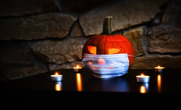 istock halloween pumpkin and medical mask 1350406211