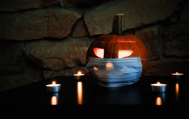istock halloween pumpkin and medical mask 1350406234