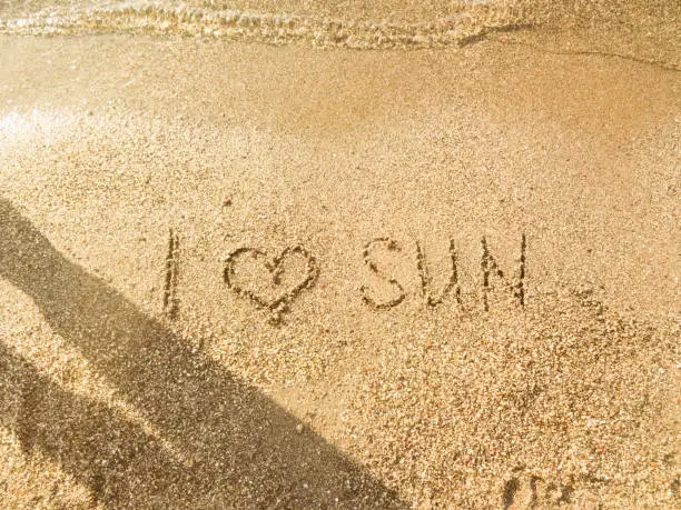 The inscription I love the sun on the sea sand - the beach in the sun