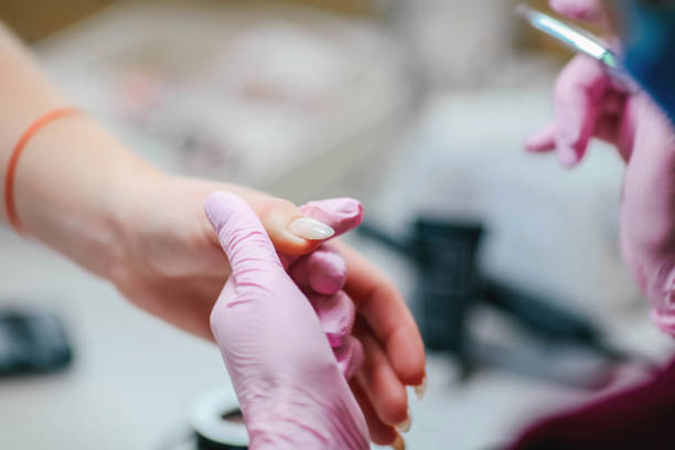 istock Young woman getting beautiful manicure in salon 1350407029