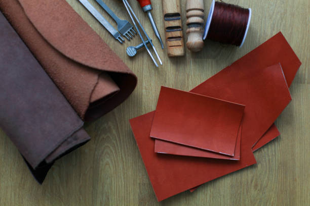 istock Craft tools for working with leather and leather material on the table. view from above. 1350409054