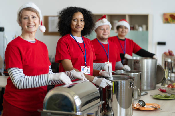 istock Volunteers ready to serve in a soup kitchen 1350409088