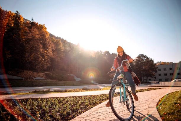 Beautiful modern woman enjoying a serene day while riding her bicycle