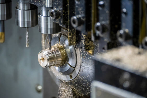 The multi-tasking CNC lathe machine tapping the brass fitting parts. The multi-tasking CNC lathe machine tapping the brass fitting parts. The hi technology parts manufacturing process by multi-tasking CNC turning machine. machining stock pictures, royalty-free photos & images