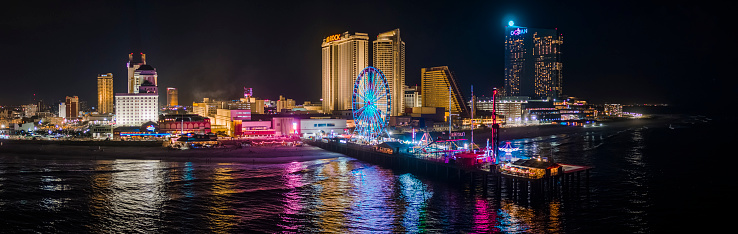 Night view of the Broadwalk along the Downtown Atlantic City's waterfront, New Jersey, USA. Extra-large high-resolution aerial stitched panorama.