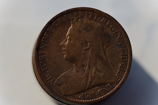 1899 UK penny obverse side featuring the robed bust of the older Queen Victoria facing left, adorned with jewellery and wearing a tiara beneath a veil (veiled head). The legend reads: 'VICTORIA-DEI-GRA-BRITT-REGINA-FID-DEF-IND-IMP-' \nBronze