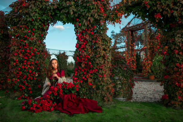 A beautiful blond princess in a public rose garden setting