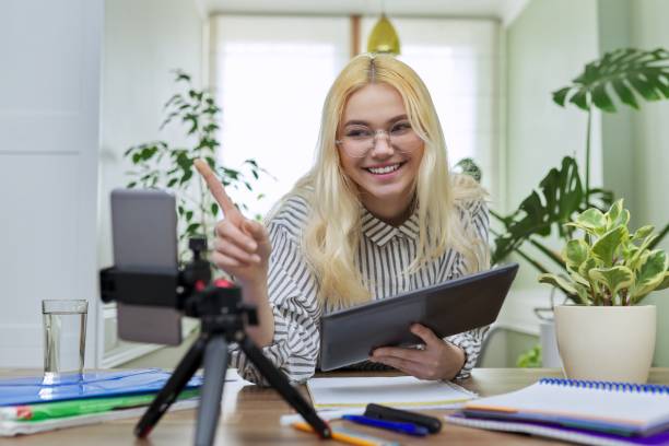 istock Female teenager student using digital tablet and smartphone for study 1350415551