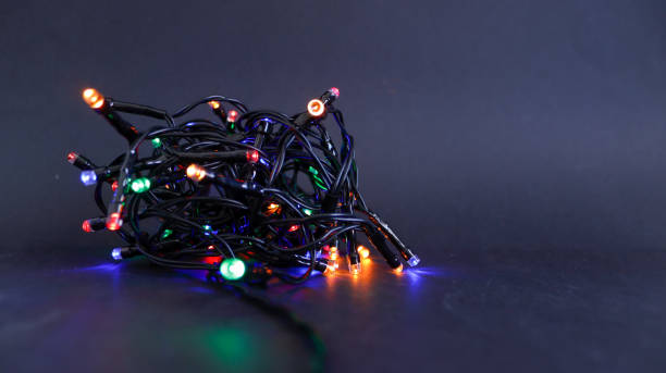 istock Christmas lights bundle close-up view on black background 1350416135