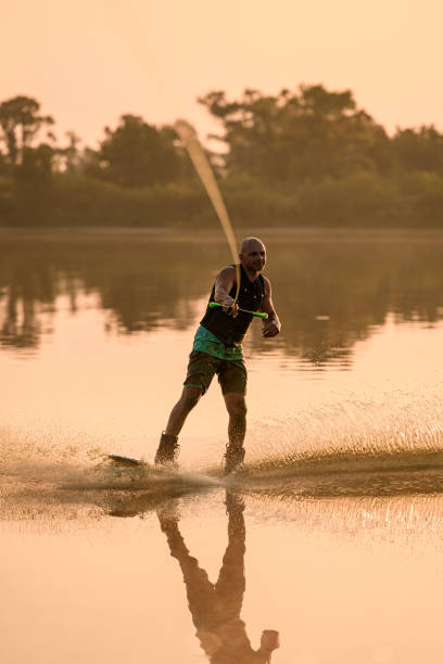 istock athletic man engaged in water sport and balancing on water surface on a wakeboard 1350418605