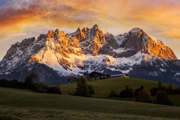 牧歌的な高山風景の日の出、ワイルダーカイザー、オーストリア、チロルの前の農家 - カイザー山脈 - アルペングロー ストックフォトと画像