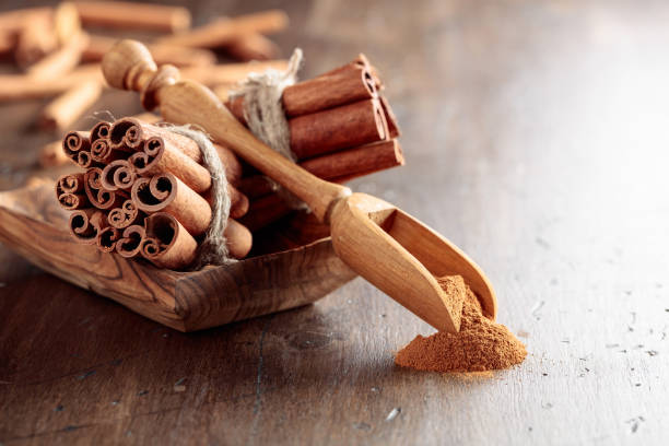 istock Cinnamon sticks and a wooden spoon with powder. 1350419738