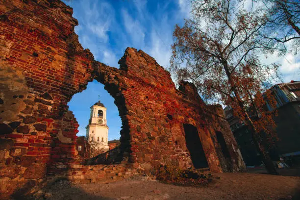 View of the Clock Tower from the ruins of the Old cathedral in the town of Vyborg, Leningrad Region in autumn.