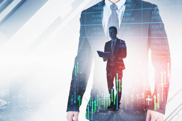istock Businessman wearing formal suit is standing and holding a book 1350423059