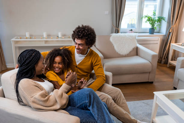 istock Cheerful parents with kid having fun at home 1350424286