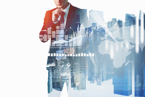 istock Businessman in suit is looking into his notes on notebook. White glowing charts and globe icon. Singapore city view, double exposure 1350424347