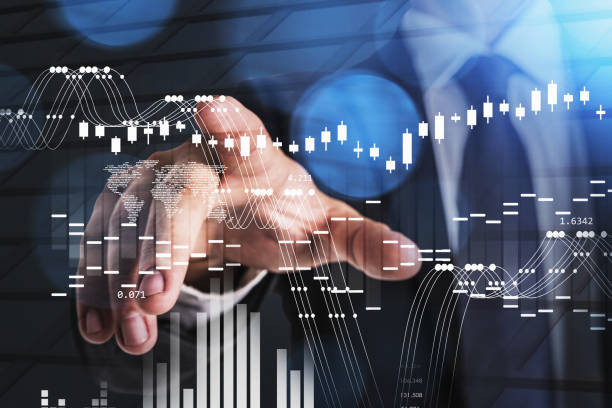 istock Businessman wearing formal suit is touching screen with forex candlesticks 1350424386