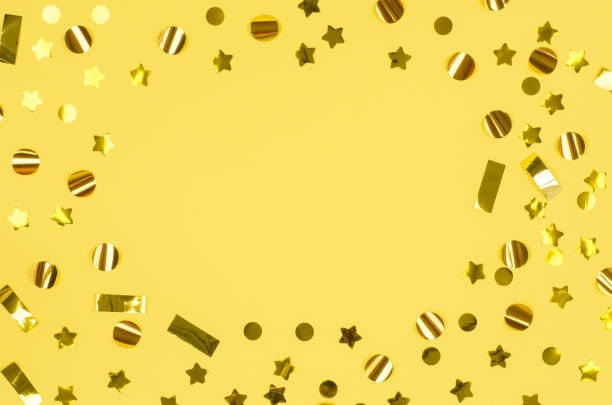 istock Festive background with place for text. Golden decorations on a pink background. Festive concept. Christmas confetti frame 1350424472