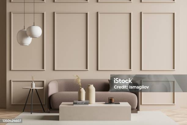 Seating Area With A Sofa Next To A Beige Living Room Wall Stock Photo - Download Image Now