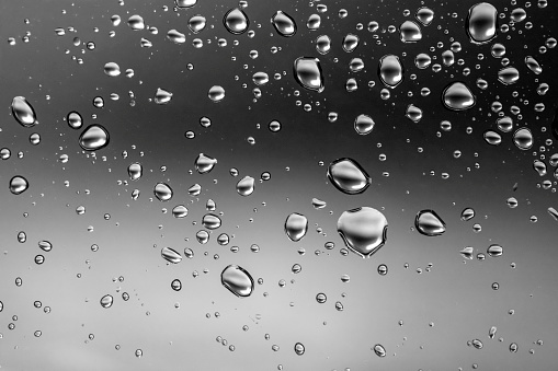 Water drops on glass, close-up background.