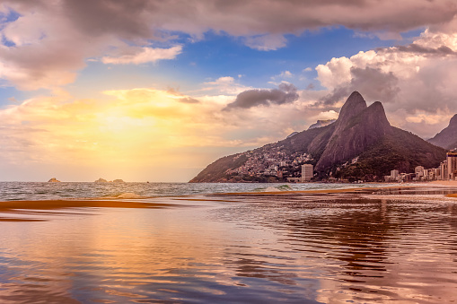Sunset time at Ipanema and Leblon beaches with the Dois Irmaos mountain in the silhouette.