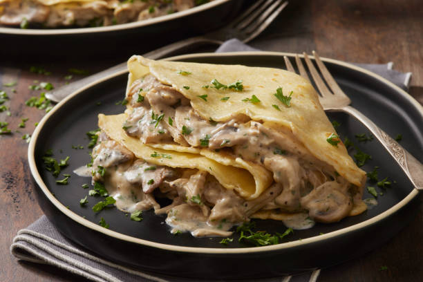 Savory Crepes with Creamy Garlic, Chicken and Mushrooms Savory Crepes with Creamy Garlic, Chicken and Mushrooms savory food stock pictures, royalty-free photos & images