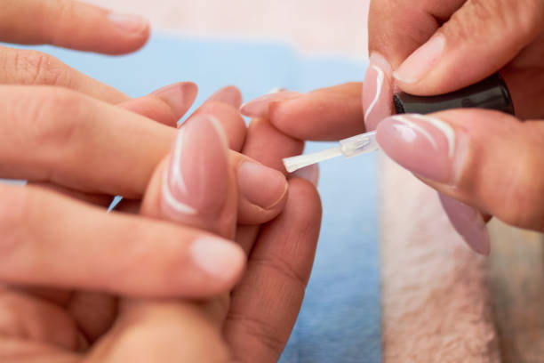 istock Young woman getting beautiful manicure in salon 1350428340