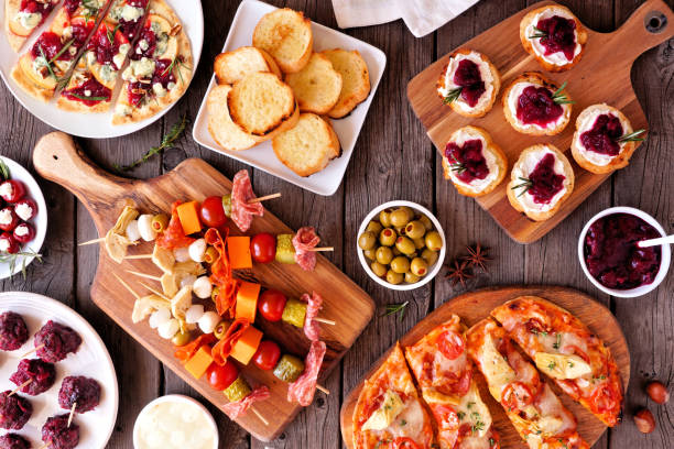 istock Winter holiday theme appetizers. Top down view table on a dark wood background. 1350428847