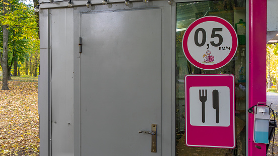 Cheerful pink road sign Restaurant. Road sign signaling food services in public park. Cafe and fast food shop concept.