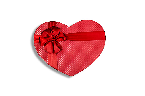 Valentine's Day background with red heart and ribbon on white background with copy space