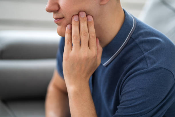 A man with toothache, periodontal disease in wisdom teeth stock photo
