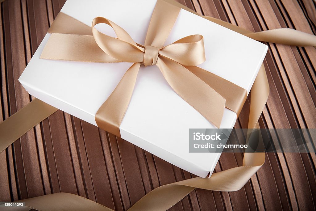 holiday scene white gift box with golden ribbon White gift box.  Canon EOS 5D MARK II Abstract Stock Photo