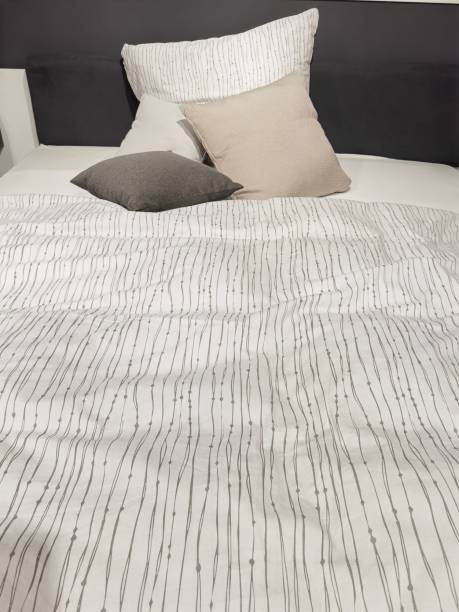istock a bed that is not tidy with a blanket and pillow 1350444174