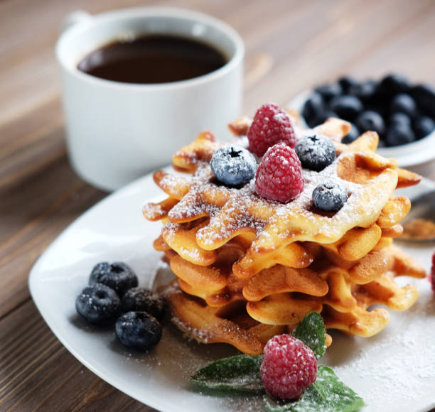 istock Waffles with berries on a white plate and coffee, close up 1350446039
