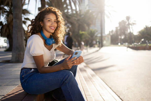 istock Woman using smart phone on vacations in Barcelona 1350448323