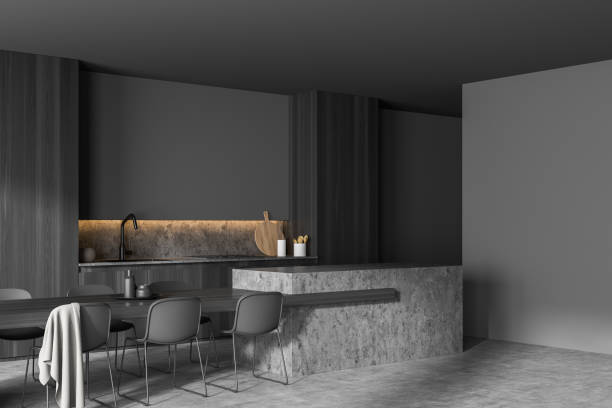 istock Corner of dark grey kitchen with stylish dining table 1350449453