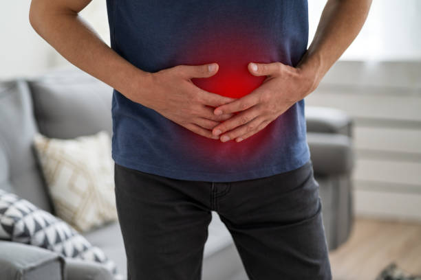 istock Stomach ache, man with abdominal pain suffering at home 1350450890