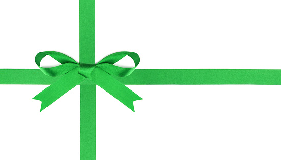 Green satin Christmas gift bow and ribbon arranged as wrapped gift box isolated on a white background