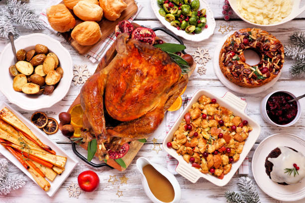 istock Classic Christmas turkey dinner. Top view table scene on a white wood background. 1350453531