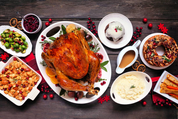 istock Traditional Christmas turkey dinner. Top view table scene on a dark wood background. 1350454446